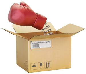 A spring-loaded boxing glove emerging from an ordinary delivery box.