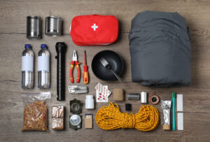 A disaster supply kit laid out on a wooden table
