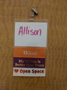 Allison's badge at an Open Space event with a "heart Open Space" ribbon