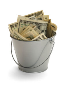 A metal pail filled with hundred dollar bills.