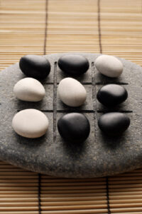 A tic-tac-toe game made from stones