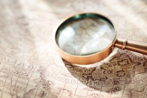 A magnifying glass sitting on an old nautical chart